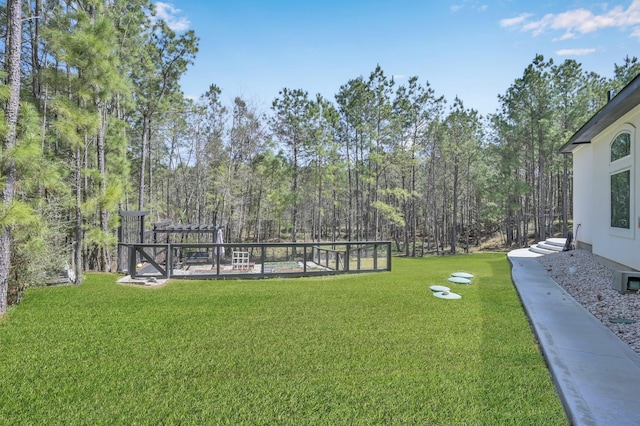 view of yard with a view of trees