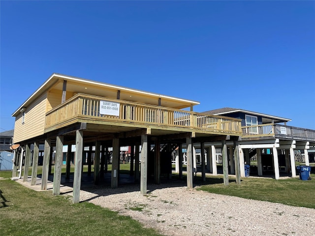 back of property featuring a carport and a yard