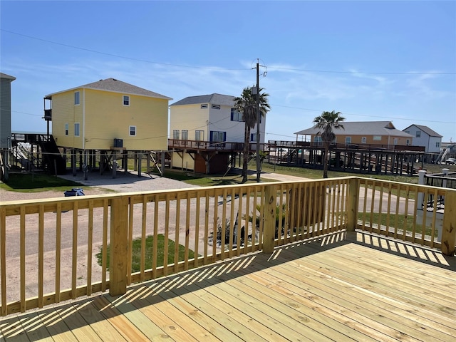 wooden deck featuring a patio area and a residential view