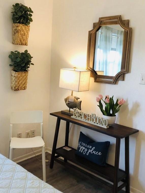 bedroom with baseboards and wood finished floors