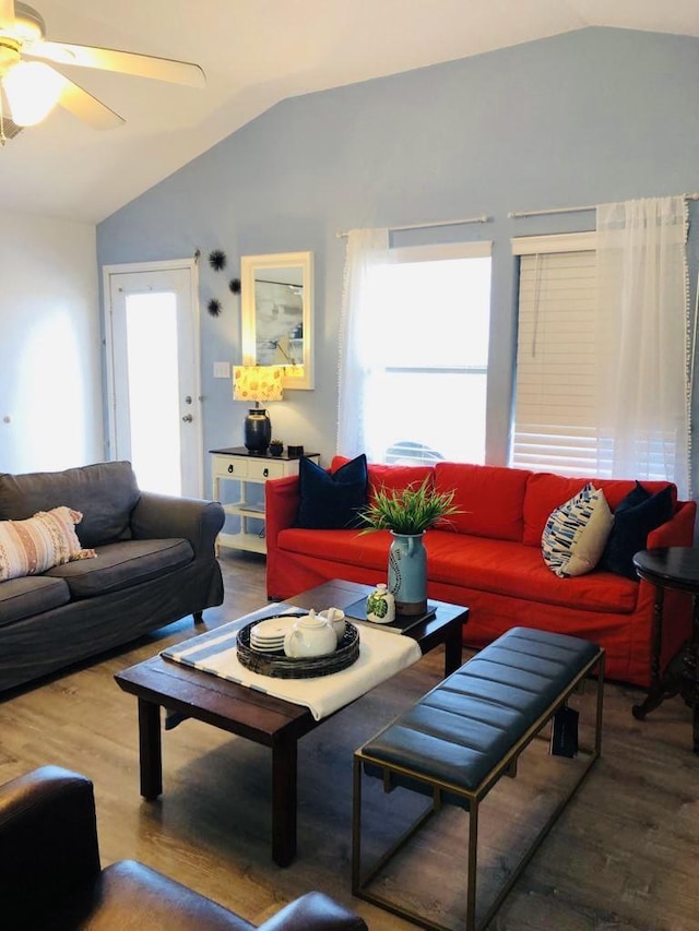 living area with wood finished floors, ceiling fan, and vaulted ceiling