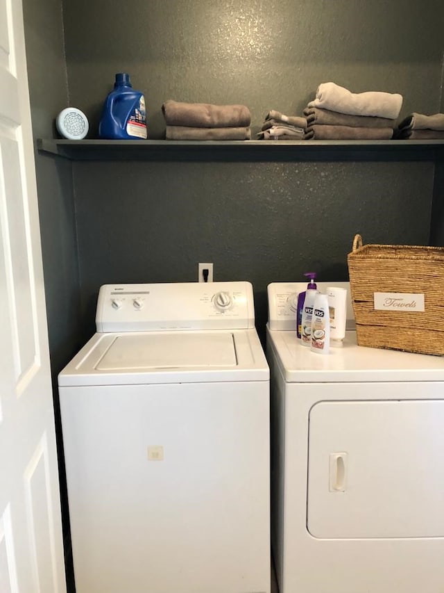 clothes washing area with washer and dryer