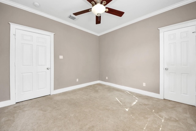 unfurnished bedroom featuring baseboards, visible vents, carpet floors, ceiling fan, and ornamental molding