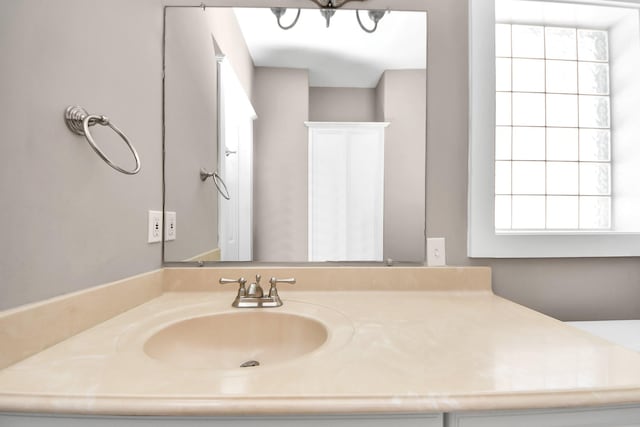 bathroom featuring an inviting chandelier and vanity