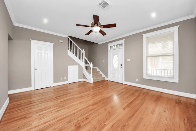 foyer entrance with light wood-type flooring, visible vents, baseboards, ceiling fan, and stairs