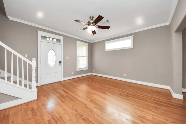 entryway featuring a ceiling fan, visible vents, light wood finished floors, and ornamental molding