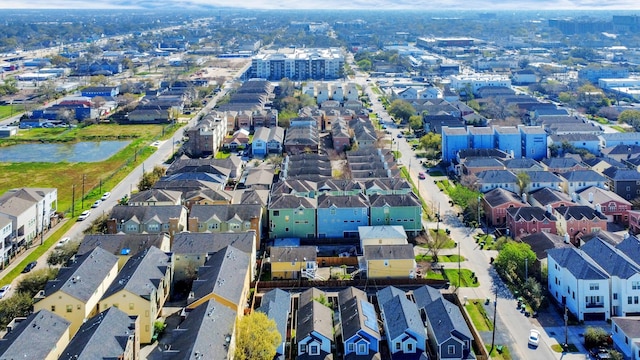 drone / aerial view featuring a residential view and a water view