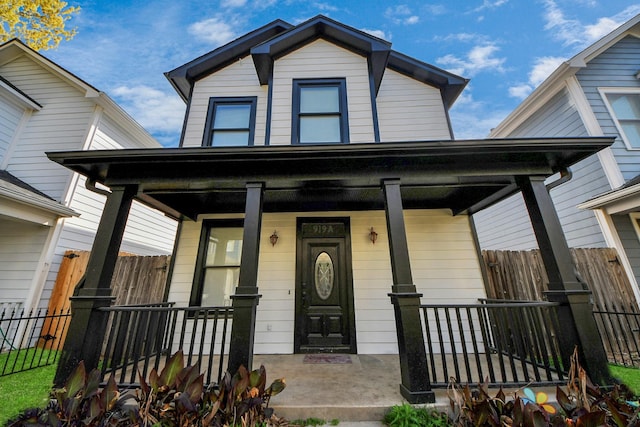 view of front of home with fence and covered porch