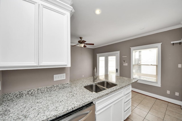 kitchen featuring a sink, ornamental molding, a ceiling fan, and white cabinetry