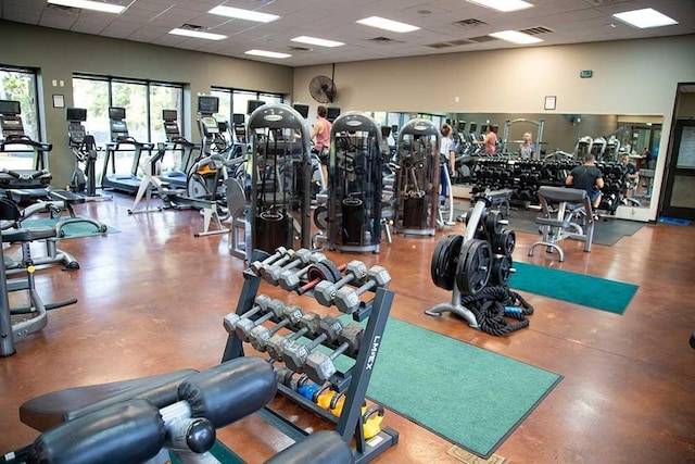 workout area with a drop ceiling and visible vents