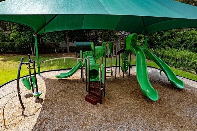 community playground with a lawn and fence