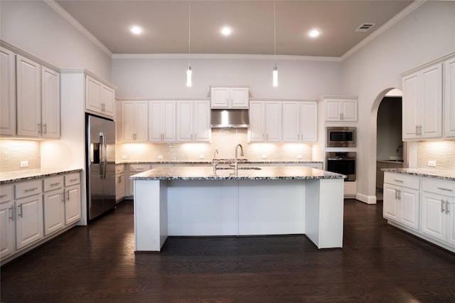 kitchen with visible vents, arched walkways, under cabinet range hood, appliances with stainless steel finishes, and crown molding