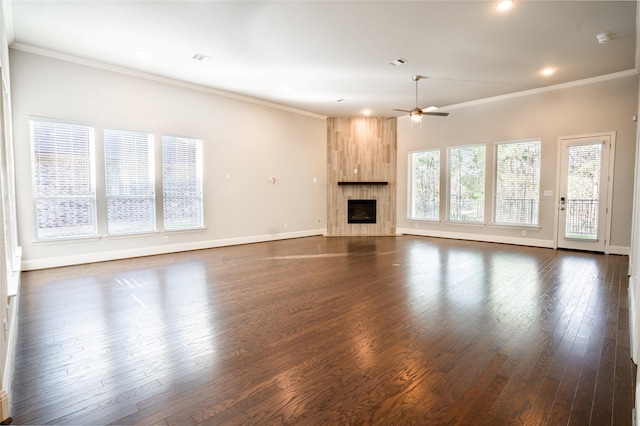 unfurnished living room with visible vents, crown molding, baseboards, ceiling fan, and dark wood-style flooring