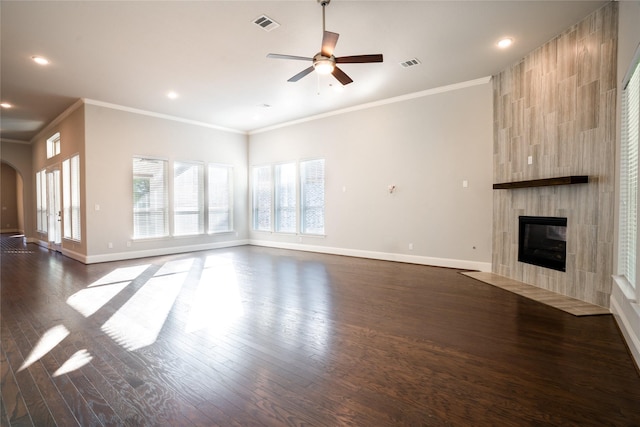 unfurnished living room with visible vents, dark wood-type flooring, ceiling fan, baseboards, and a tiled fireplace