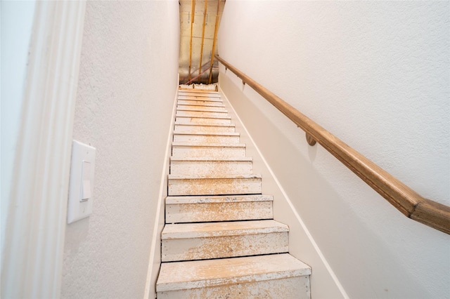 stairway with a textured wall