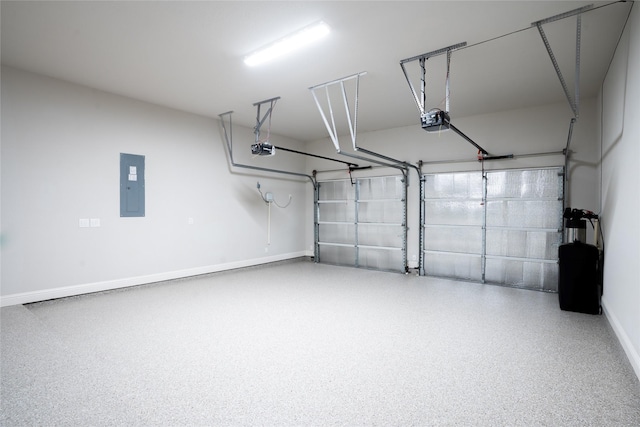 garage featuring electric panel, a garage door opener, and baseboards