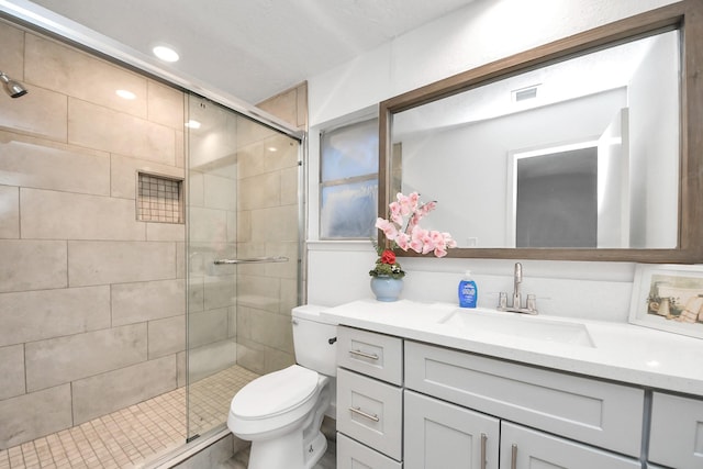 bathroom with vanity, visible vents, recessed lighting, a shower stall, and toilet