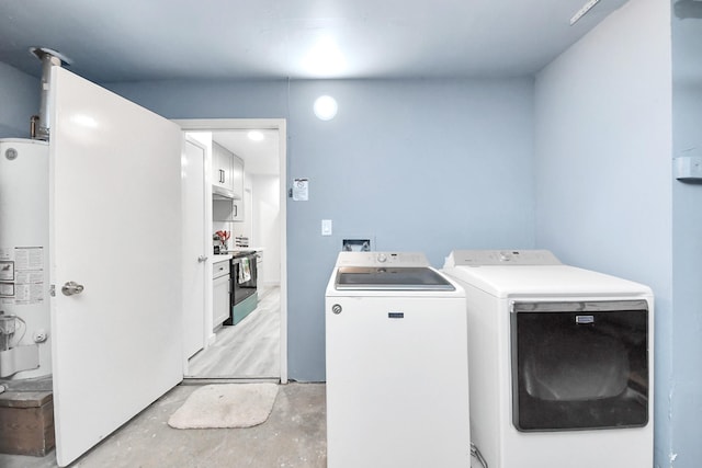 laundry area featuring water heater, laundry area, and independent washer and dryer