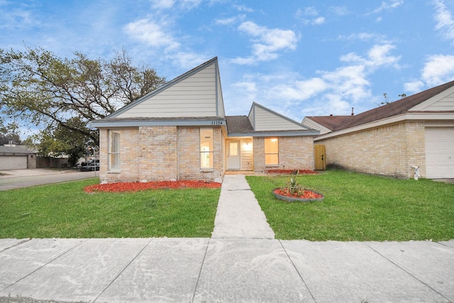 view of front of property with brick siding and a front yard