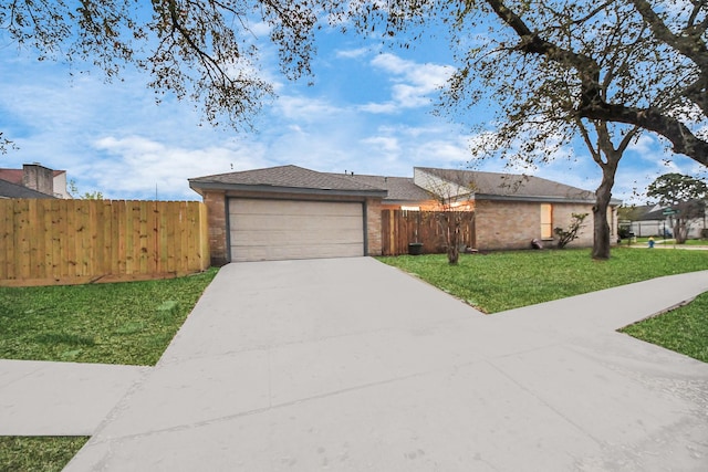 view of front of home featuring a front yard, fence, an attached garage, concrete driveway, and brick siding