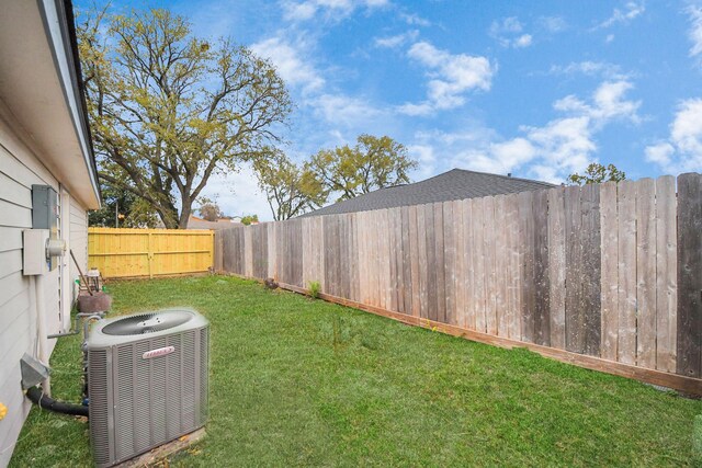 view of yard featuring central air condition unit and a fenced backyard