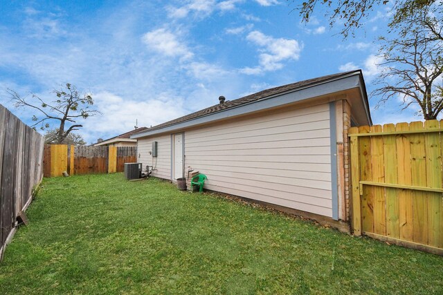 exterior space with cooling unit and a fenced backyard