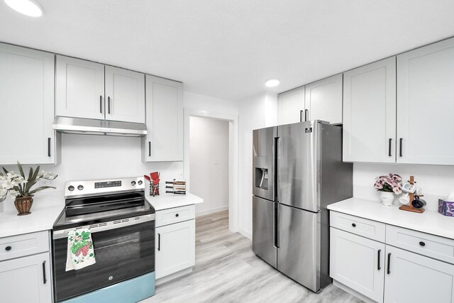 kitchen with baseboards, light countertops, under cabinet range hood, appliances with stainless steel finishes, and light wood-type flooring