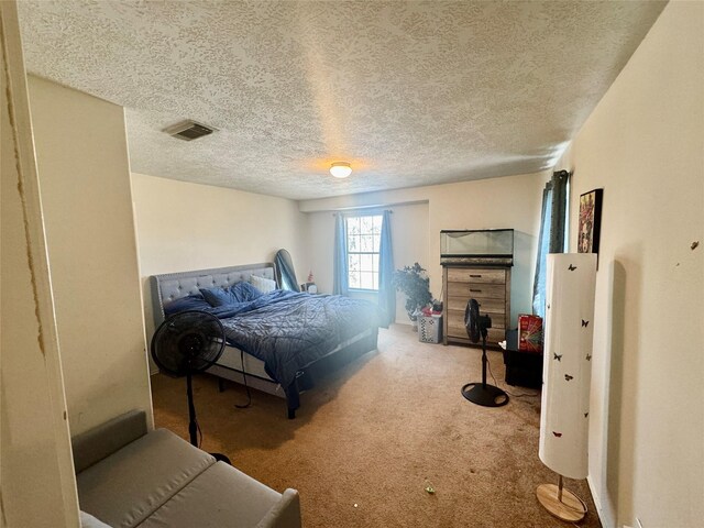 carpeted bedroom featuring visible vents and a textured ceiling