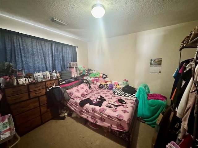 bedroom with visible vents and a textured ceiling