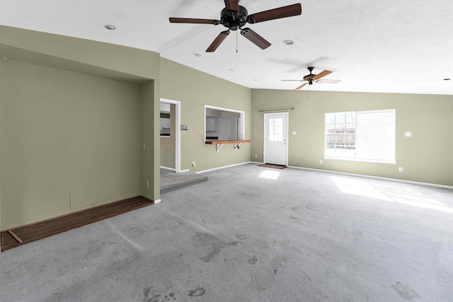 unfurnished living room with baseboards, lofted ceiling, carpet floors, and ceiling fan