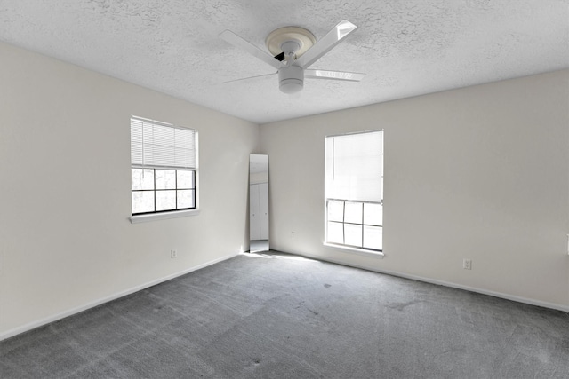 unfurnished room featuring a ceiling fan, baseboards, carpet floors, and a textured ceiling