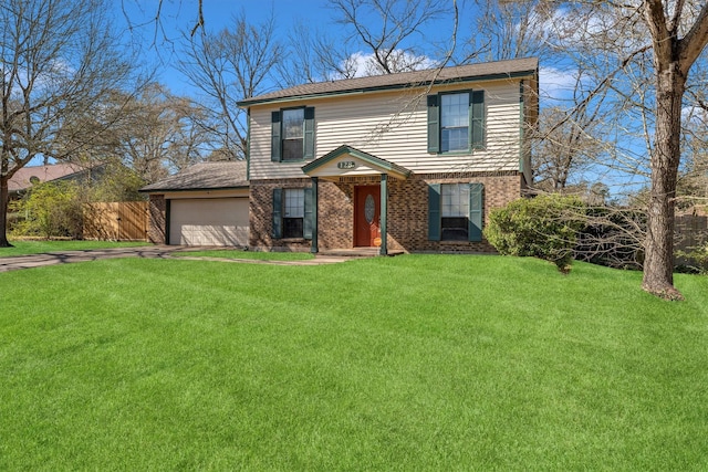 traditional-style home featuring a front yard, fence, driveway, an attached garage, and brick siding