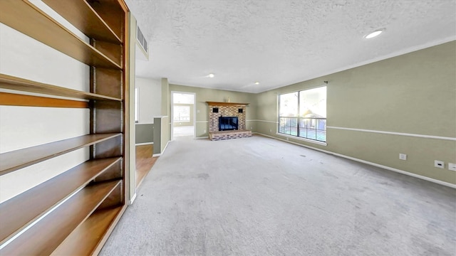 unfurnished living room featuring a wealth of natural light, a textured ceiling, and a fireplace