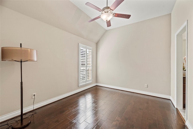 empty room with lofted ceiling, a ceiling fan, dark wood-style flooring, and baseboards