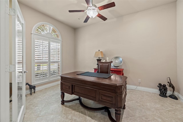 office area featuring light tile patterned floors, baseboards, and ceiling fan