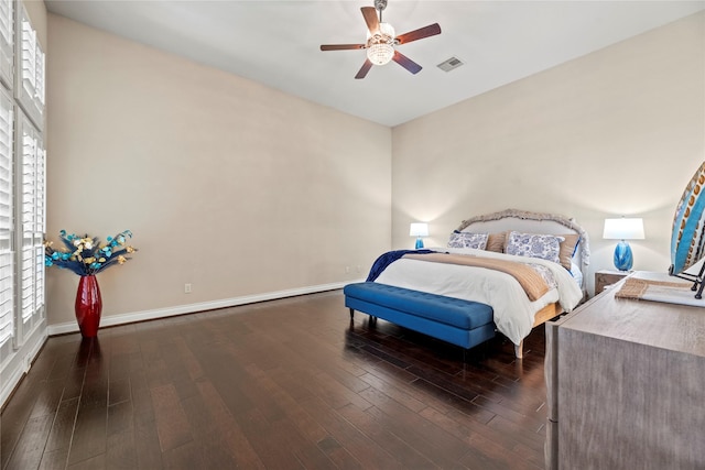 bedroom with visible vents, ceiling fan, baseboards, and dark wood-style flooring