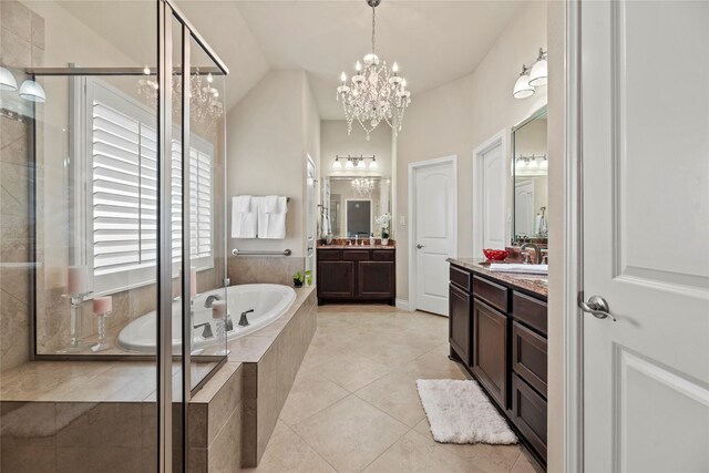 full bath with tile patterned floors, a garden tub, two vanities, a stall shower, and a sink