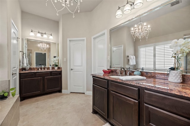 bathroom with a sink, visible vents, a notable chandelier, and two vanities