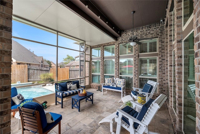 sunroom featuring ceiling fan