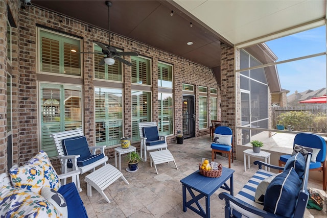 view of patio / terrace featuring an outdoor hangout area, a lanai, and a ceiling fan