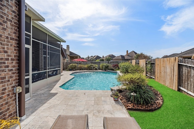 view of pool with a fenced in pool, a yard, a fenced backyard, a sunroom, and a patio area