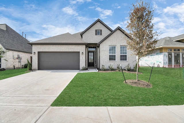 view of front of home featuring a garage, brick siding, concrete driveway, and a front yard