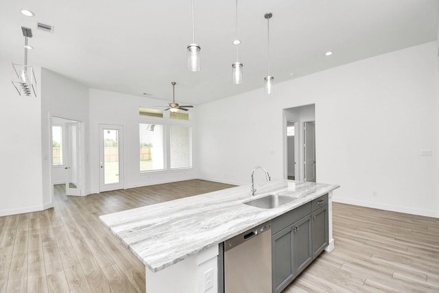 kitchen with dishwasher, gray cabinetry, light wood finished floors, and a sink