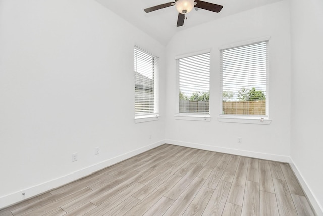 unfurnished room featuring baseboards, light wood-style flooring, a ceiling fan, and vaulted ceiling