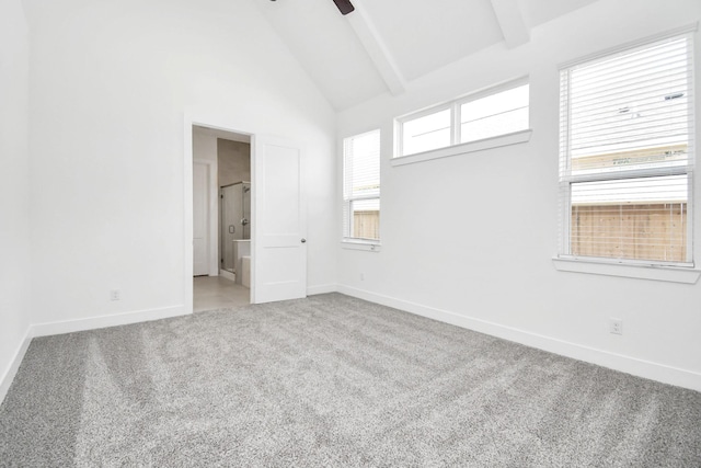 empty room featuring beamed ceiling, high vaulted ceiling, baseboards, and carpet floors