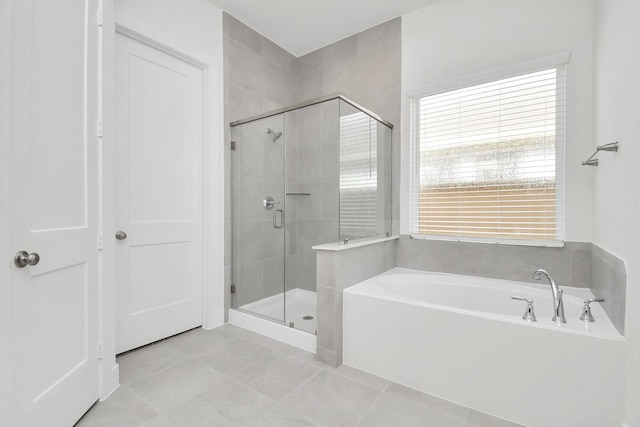 bathroom with tile patterned floors, a garden tub, and a stall shower