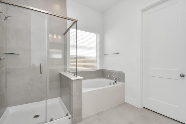 bathroom featuring a stall shower and a garden tub