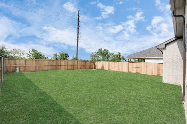 view of yard with a fenced backyard