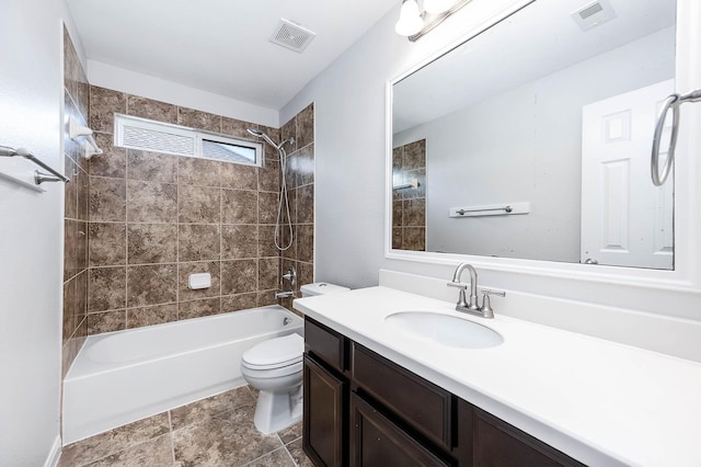 bathroom with visible vents, shower / bathtub combination, toilet, and vanity