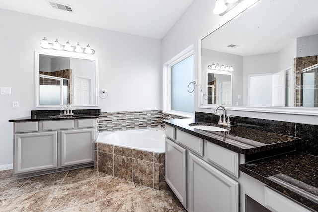 full bath featuring a sink, visible vents, a bath, and a shower stall